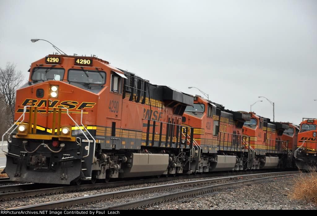 Intermodal rolls past tied down grain train